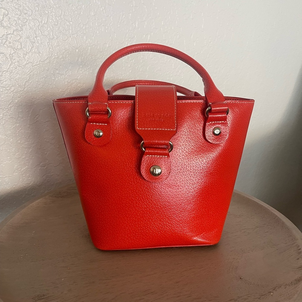 Bright burnt orange Kate Spade bucket bag